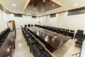 a conference room with a long table and chairs at Zizina Otis Resort in Guwahati