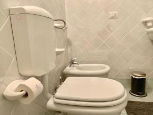 a bathroom with a white toilet and a sink at Casa Panke in Scicli +22 photos