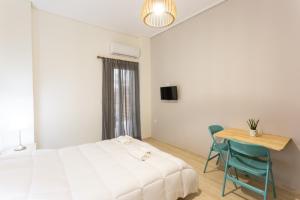 a bedroom with a bed and a desk and a table at Cloud 3 Apartment in Kalamata