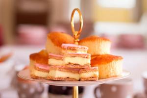 a stack of pastries on a plate on a table at Bed & Breakfast de Appelaar in Rijs