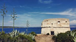 an old stone building next to the water at La casa del viaggiatore in Codrongianos