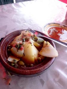 a bowl of food on a table with a plate of food at Mustapha 3 in Nador