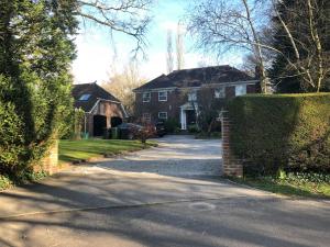 a house with a driveway in front of it at Idyllic Studio Flat in Winchester