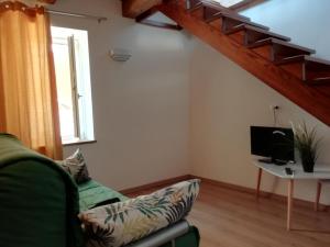a living room with a couch and a tv at Casa Mancusa in Badolato