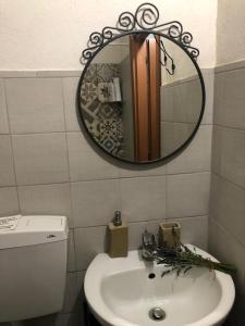 a bathroom with a sink and a mirror at Apartment Trezza in Acitrezza