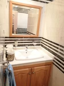 a bathroom with a sink and a mirror at la baie de Tanger in Tangier