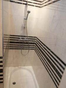 a bath tub in a bathroom with a shower at la baie de Tanger in Tangier +44 photos