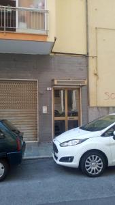 two cars parked in front of a building at Relax e mare in Savona