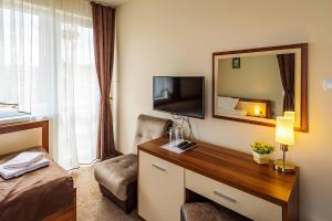 A television and/or entertainment centre at Family Hotel Bulgaria