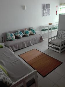 a living room with a couch and a table at Ruffus Beach House in Portimão