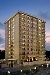 a large building with lights in front of it at Residency Sarovar Portico in Mumbai