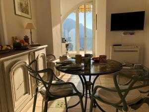 a living room with a table and chairs and a television at La Casa di Vania in Ravello