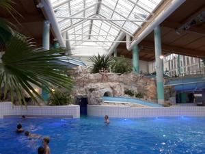 a pool in a building with people in the water at Roubenka Janka in Bublava