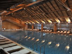 a large indoor swimming pool with chairs in it at Bianca Resort & Spa in Kola&scaron;in