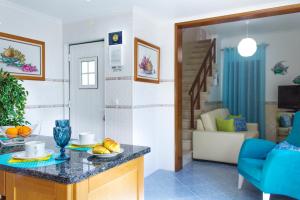 a kitchen and living room with a table and a couch at HouseBea in Nazaré