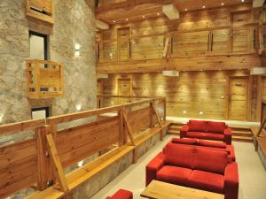 a room with two red chairs and wooden walls at Bianca Resort & Spa in Kola&scaron;in