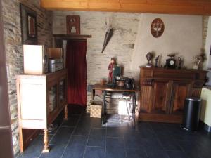 a kitchen with a refrigerator and a table in a room at Gite les Camélias in Sainte-Anne-sur-Vilaine