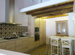 a kitchen with wooden cabinets and a stove top oven at Apartamento Zocailla Suite in Gata