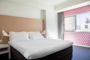 A bed or beds in a room at Stay Hotel Faro Centro