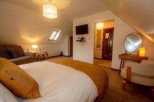 a bedroom with a large bed and a living room at Uircheann Righ in Strontian