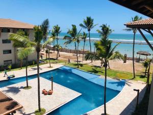 a view of the beach from the balcony of a resort at La Fleur Polinesia Residence & Resort in Porto De Galinhas