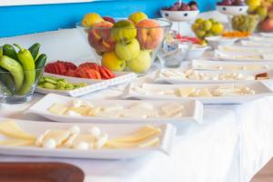 a table filled with plates of cheese and fruit at Miramar Pansiyon in Kaş