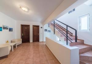 a large hallway with stairs and a stair case at Miramar Pansiyon in Kaş