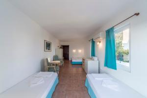 a room with two beds and a window at Miramar Pansiyon in Kaş