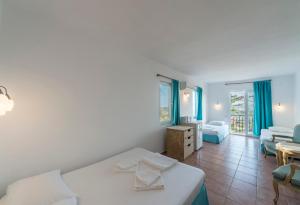 a bedroom with a bed and a living room at Miramar Pansiyon in Kaş