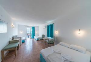 a hotel room with a bed and a living room at Miramar Pansiyon in Kaş