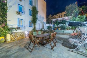 a table and chairs in front of a building at Miramar Pansiyon in Kaş