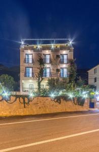 a building with lights in front of a street at Miramar Pansiyon in Kaş