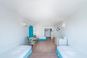 a hospital room with two beds and a table at Miramar Pansiyon in Kaş