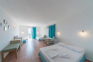 a hotel room with two beds and chairs at Miramar Pansiyon in Kaş