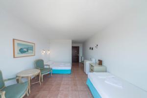 a hospital room with two beds and chairs at Miramar Pansiyon in Kaş