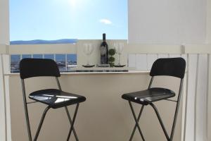 two black and white chairs sitting at a kitchen counter at Full View in Mostar