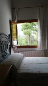 a bedroom with a bed in front of a window at Saluda Alta in Castril