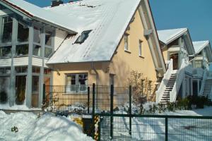 a house with a snow covered roof at FeWo an der Ostsee Nr. 1 in Rerik