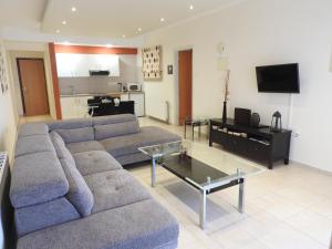 a living room with a couch and a table at Hill View Hotel Apartments in Pissouri