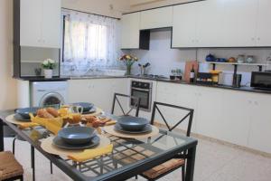 a kitchen with a table with dishes on it at Salt Lake Town House in Larnaca