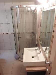 a bathroom with a sink and a shower at Hill View Hotel Apartments in Pissouri