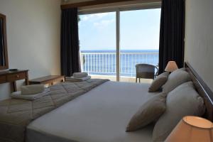 Postel nebo postele na pokoji v ubytování Hotel Cokkinis