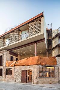 a large brick building with a balcony on top of it at Somiatruites in Igualada