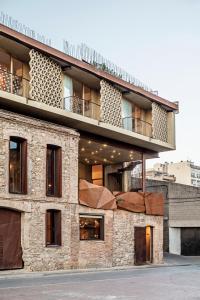 a brick building with a balcony on top of it at Somiatruites in Igualada