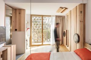 a bedroom with a bed and a large window at Somiatruites in Igualada