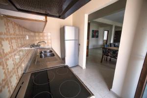 a kitchen with a stove and a refrigerator at Luminous Apartment in Agia Triada