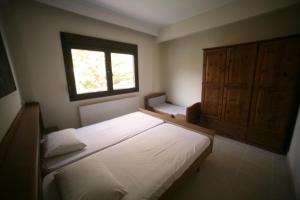 a bedroom with two beds and a window at Luminous Apartment in Agia Triada