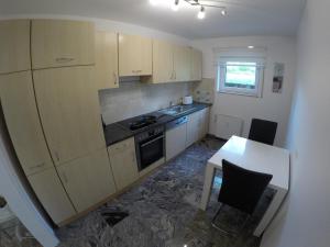 a small kitchen with a stove and a table at Ferienwohnung Hecker in Rastatt