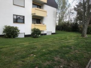 a house with a green yard in front of it at Ferienwohnung Hecker in Rastatt