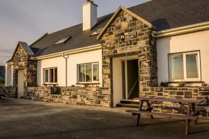 a house with a picnic table in front of it at The Pipers Rest in Doolin